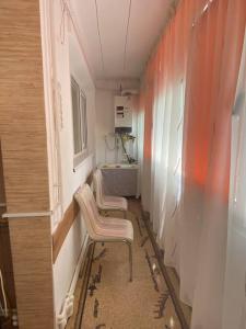 a hallway with two chairs in a room at Apartment for rent in Galaţi