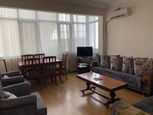 a living room with a couch and a table at Apartment 3 bedrooms in Yalova