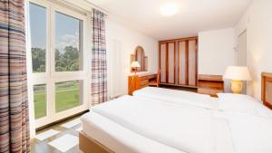 Letto o letti in una camera di Hapimag Resort Ascona