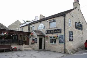 a brick building with a restaurant in front of it at The New Rushcart Inn & Country Dining in Sowerby Bridge