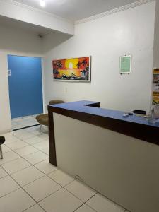 an office with a blue counter and a blue door at Pousada o Paraiso in Camamu