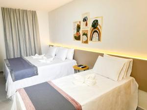 a hotel room with two beds and a window at Haki Hotel in Patos