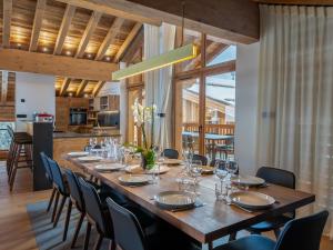 a dining room with a large wooden table and chairs at Chalet Courchevel 1550, 7 pièces, 14 personnes - FR-1-562-47 in Courchevel