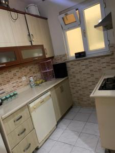 a kitchen with wooden cabinets and a stove top oven at Apartment 3 bedrooms in Yalova