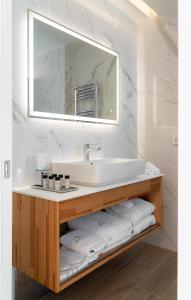 a bathroom with a sink and a mirror at Athens Hill Luxury Apartments in Athens +41 photos