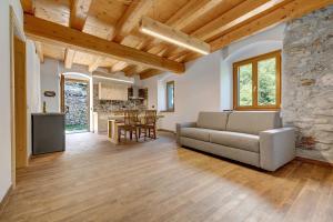 a living room with a couch and a table at Casa al Mulino 1 in Tenno +19 photos