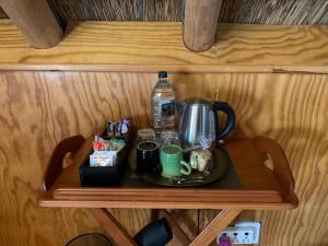 a tray with a coffee maker and drinks on a shelf at Port Wine Guesthouse in Calitzdorp