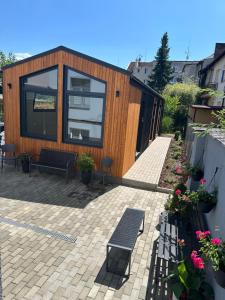 a wooden house with a bench on a patio at Pension Skylark in Pardubice