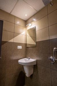 a bathroom with a sink and a mirror at MERIDIAN BY Daan in Trivandrum