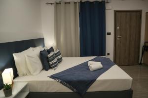 a bedroom with a large bed with a blue curtain at Veranda-Ammoudara-Crete in Amoudara Herakliou