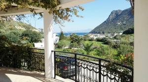 a balcony of a house with a view of the ocean at beautiful villa in Kefalos