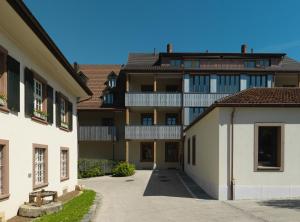 an empty courtyard of a large apartment building at Hotel Sonne Sissach in Sissach