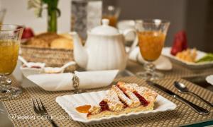 a table with a plate with a piece of cake at Albergo Diffuso Birkin Castello in Cagliari