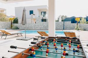 a pool table with ping pong balls on it at Apartments Aqua in Malinska