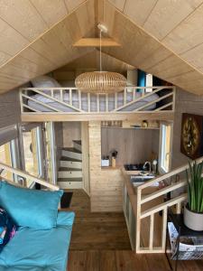 a tiny house with a kitchen and a living room at Tiny house du Château du Boulay-Morin in Le Boulay-Morin