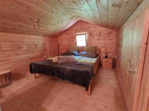 a bedroom with a bed in a wooden cabin at Reithütte in Krispl
