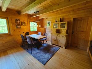 a dining room with a table and chairs in a cabin at Reithütte in Krispl
