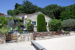 a house with a table and chairs in front of it at Apartments La Vieille Source in Saint-Martin-dʼArdèche