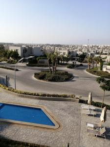 a resort with a swimming pool and a city at Premium Sea View Chalet in Azha Ain Sokhna in Ain Sokhna