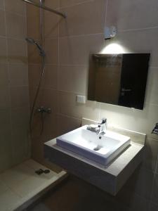 a bathroom with a sink and a mirror and a shower at Premium Sea View Chalet in Azha Ain Sokhna in Ain Sokhna