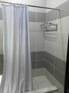 a shower with a white shower curtain in a bathroom at Premium Sea View Chalet in Azha Ain Sokhna in Ain Sokhna