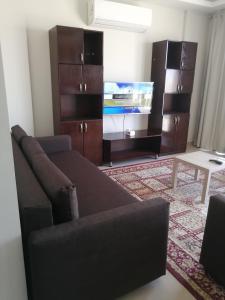 a living room with a couch and a flat screen tv at Premium Sea View Chalet in Azha Ain Sokhna in Ain Sokhna