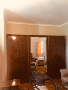 a living room with a large wooden cabinet in a room at Exotic in Nabran