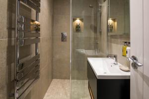 a bathroom with a shower and a sink at Housel Bay Hotel in Lizard