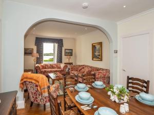 a living room with a table and a couch at Neptune Cottage in Rockcliffe