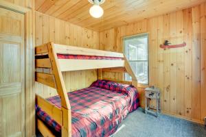 a bedroom with a bunk bed in a cabin at Lakefront Wisconsin Home - Deck, Fire Pit and Kayaks in Stone Lake