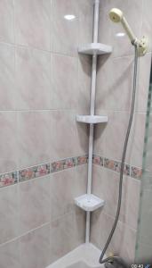 a shower with a shower head and a shower at Entire Immaculate 3 Bedrooms House in Blackburn Weekend Away in Blackburn