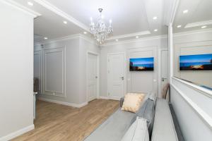 a living room with a couch and a chandelier at Premium Apartment Chisinau in Chişinău