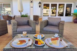 a coffee table with breakfast foods on top of it at Boutique Hotel Oriola in Cala de Sant Vicenc