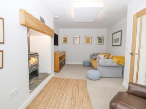 a living room with a fireplace and a couch at Bryn Tirion in Holyhead