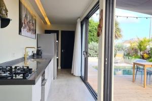 a kitchen with a sink and a counter top at Boutique appartment 4P with PRIVATE POOL, close by Jan Thiel & Mambo beach in Willemstad
