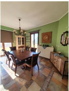 a dining room with a wooden table and chairs at beautiful villa in Kefalos