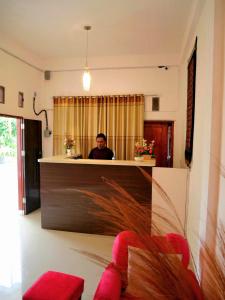 a man sitting at a counter in a room at The Sanduk Homestay in Rantepao