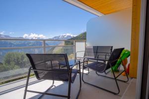 two chairs and a table on a balcony with a view at Studio Orilla - Welkeys in LʼHuez