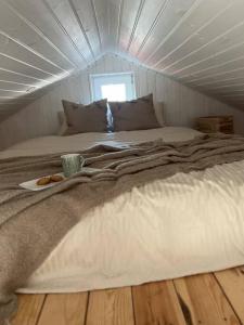 a large bed in a room with a ceiling at Oak Heart, Lucavsalas namiņš in Rīga