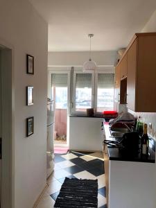 a kitchen with a black and white checkered floor at Blerta's apartment in Prizren