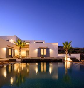 a villa with a swimming pool at night at White Dream Suites Antiparos in Antiparos