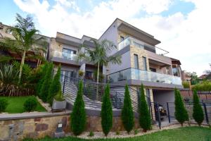 a house with trees in front of it at Supreme Villa in Kigali