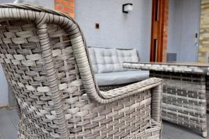 een rieten stoel naast een tafel bij Supreme Villa in Kigali