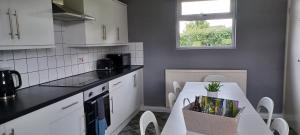 a kitchen with a table and a white counter top at Little Harries Cottage - surrounded by open fields in Ripon