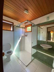 ein Badezimmer mit Glasdusche und Toilette in der Unterkunft Condominio Vila dos Ventos in Icaraí