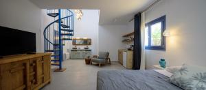 a bedroom with a bed and a blue spiral staircase at White Dream Suites Antiparos in Antiparos