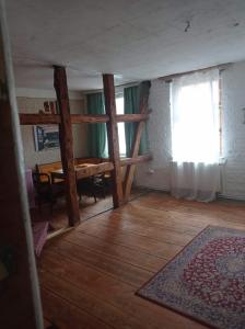 a living room with a table and a window at Velo Dahme - Appartement in historic building in Dahme