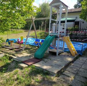 a playground with a slide and a swing set at chalet La vigna casa vacanze in Scurcola Marsicana