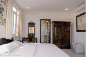 Postel nebo postele na pokoji v ubytování Hue Nino Hotel