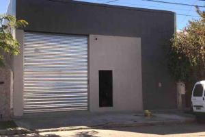 a garage with a door and a van parked in front of it at apart trelew 1 in Trelew
